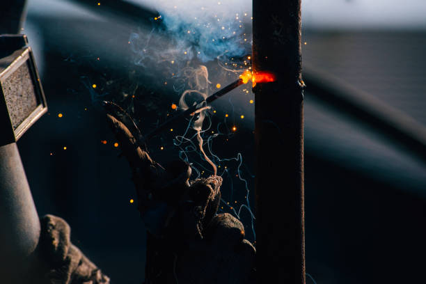 istock man working with welder steel Using electric welding machine outdoor 1217767419