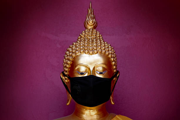 istock bhuddha statue with black mask to protect covid 19 1217768027
