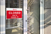 Business center closed due to COVID-19, sign with sorry in door window. Stores, restaurants, offices, other public places temporarily closed