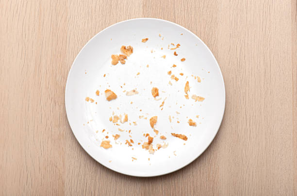 White Plate with Crumbs, dish with bread crumbs, top view
