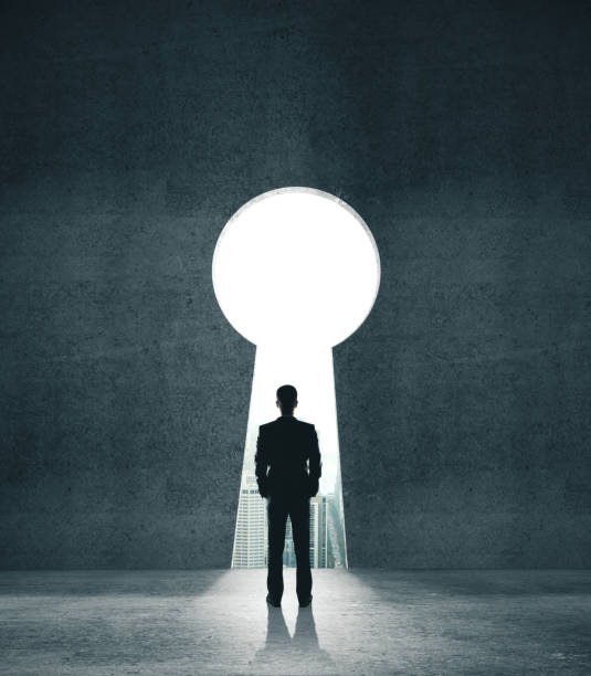 istock Businessman looking to opened concrete wall 1217769504