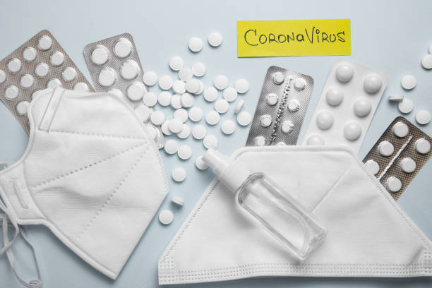 istock Coronavirus phrase text on a grey background with pills, sanitizer 1217769679
