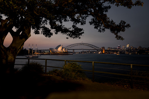 Harbor Bridge and Sydney Opera House at dusk in Sydney, Australia.