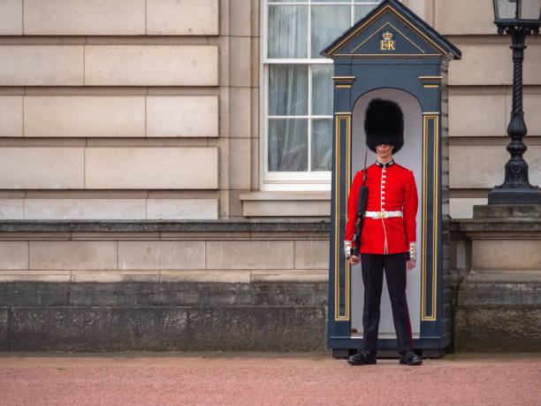 English guard patrolling at Buckingham Palace London, UK - April, 2019: English guard patrolling in London. Solider of Buckingham palace, London England. Queen's Guard - Buckingham Palace. buckingham palace photos stock pictures, royalty-free photos & images