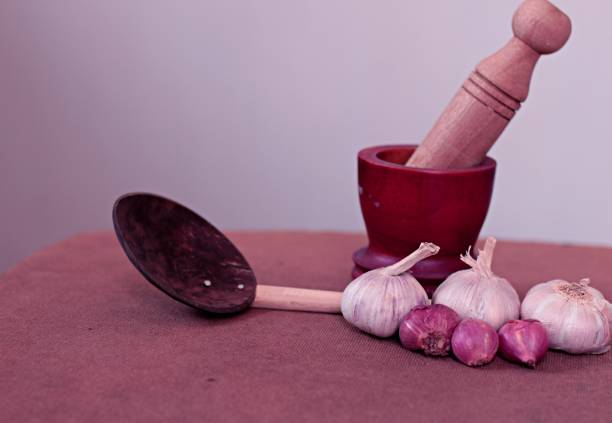 Traditional cooking tools with garlic and onions