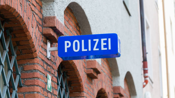 Polizei sign at the facade of a police station - Munich, Bavaria / Germany Munich, Bavaria / Germany - Feb 21, 2020: Polizei sign at the facade of a police station (Polizeiinspektion 11, Hochbrückstraße). White letters, blue background. 16:9 panorama. Keepers of law & order. police station stock pictures, royalty-free photos & images