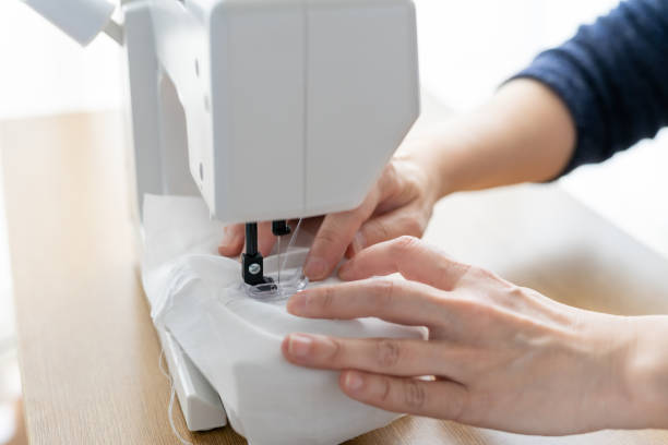 istock Asian woman sewing homemade protective mask 1217778830
