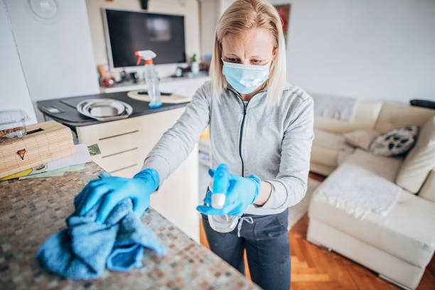 istock One woman cleaning and doing disinfection on all surfaces 1217787321