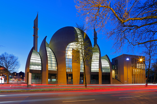 Cologne, Germany - April 07, 2020. The Central Mosque is designed by German architect Paul Böhm in non-Ottoman style - with concrete and glass. The building is one of the biggest mosque in Europe. Fast road (Innere Kanalstraße) in front.