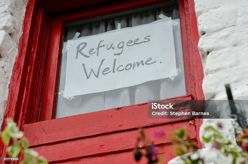 Sign on a window saying "Refugees Welcome" Refugee Stock Photo