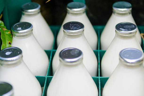 Traditional foil capped milk bottles in a crate.