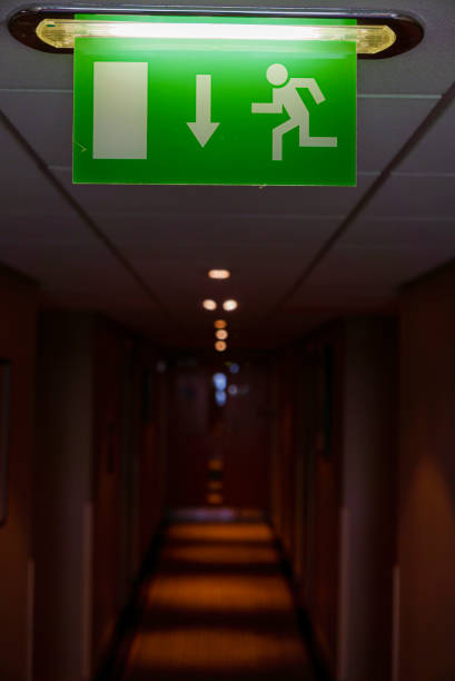 istock Fire escape sign in a dark hotel corridor. 1217792263