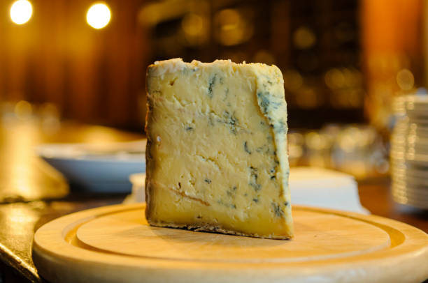 istock Piece of raw (unpasteurised) blue cheese on a cheeseboard. 1217792488