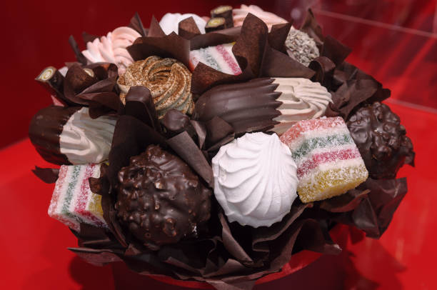 istock Holiday gift bouquet with sweets on red background. 1217793353