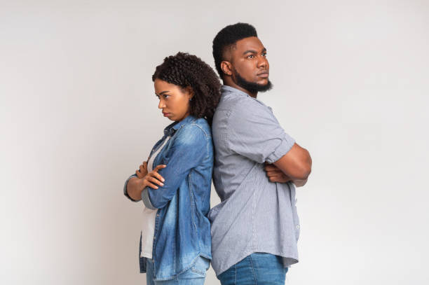 istock Offended black couple standing back to back ignoring each other 1217794011