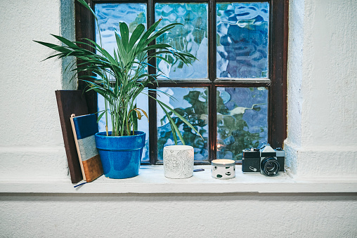 Shot of various objects on a windowsill at home