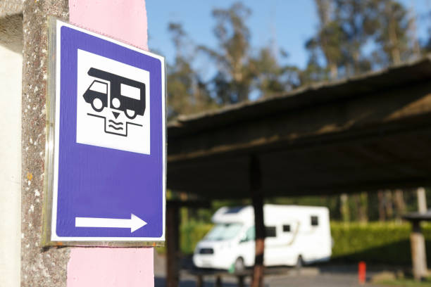 A blue sani-dump sign with a direction arrow