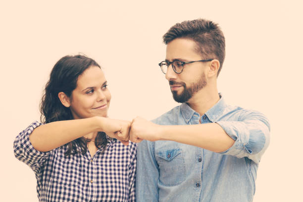 istock Satisfied couple making fist bump gesture 1217796130