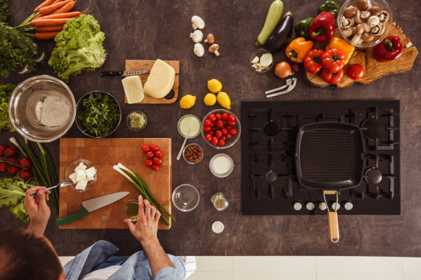 istock Man preparing ingredients and vegetables for a salad he is about to make 1217796371
