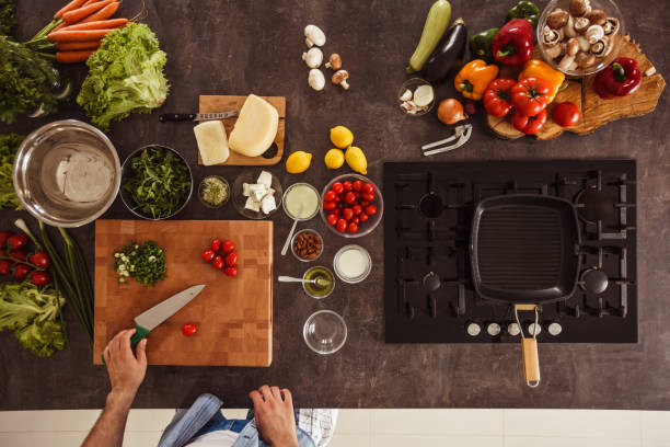 istock Man about to chop cheery tomatoes 1217796375