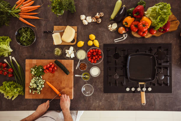 istock Man cutting up vegetables for a salad 1217796380