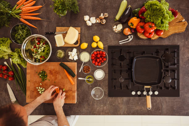 istock Adding chopped vegetables into a salad bowl 1217796381