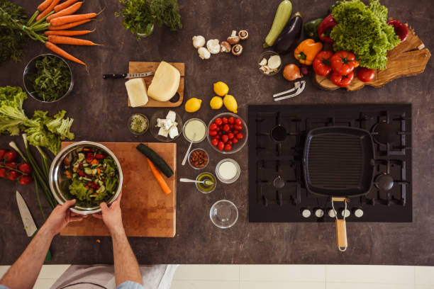 istock Unrecognizable man preparing healthy vegetarian salad 1217796382