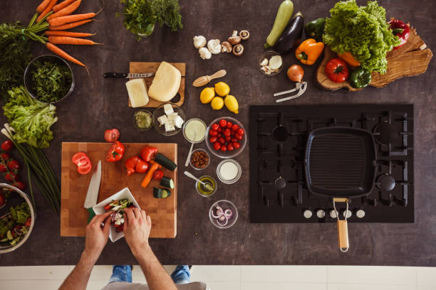 istock Adding purple onion in a salad 1217796394