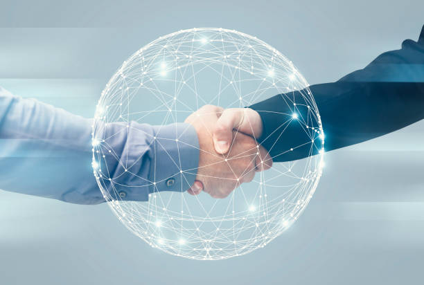 istock Two Unrecognizable Businessmen Handshaking Over Holographic Earth Globe, Double Exposure 1217801543