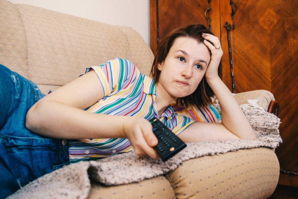 istock Woman changing channels stock photo 1217801670