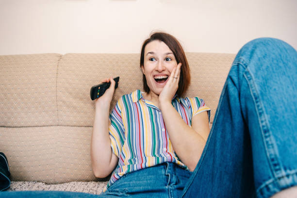 istock Woman changing channels stock photo 1217802378