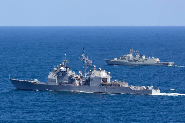 Sydney, Australia - October 11, 2013: USS Chosin (CG-65) Ticonderoga-class guided-missile cruiser and Royal Australian Navy Anzac-class frigate HMAS Parramatta sailing at sea.