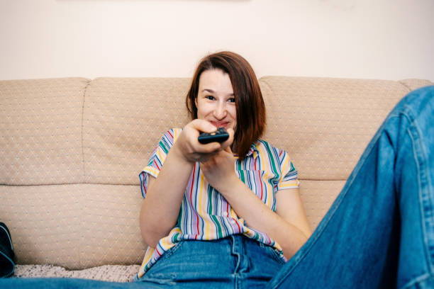 istock Woman changing channels stock photo 1217802494