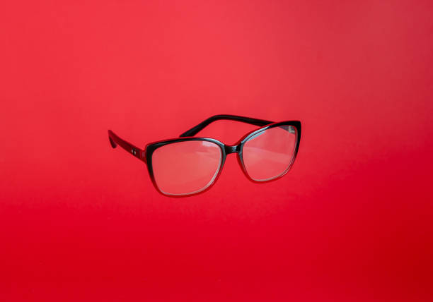 istock Reading glasses on a red background. Levitation. Design. Mock-up. Copy space. Minimal concept. 1217803342