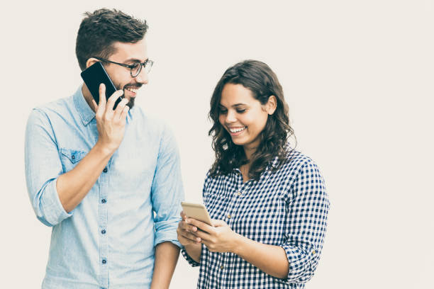 istock Happy cheerful couple calling on mobile phones 1217803466
