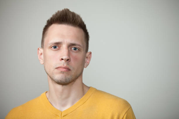 istock studio portrait of a young man on a gray background 1217803809