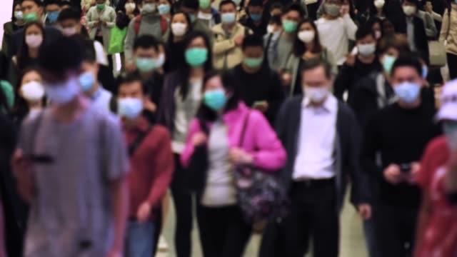 Slow motion of crowd people wearing medical face masks at metro in Hong Kong. Coronavirus concept
