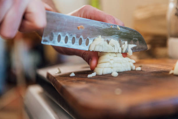 Chopping Onions Close up of an unrecognisable person cutting an onion. chopping food stock pictures, royalty-free photos & images