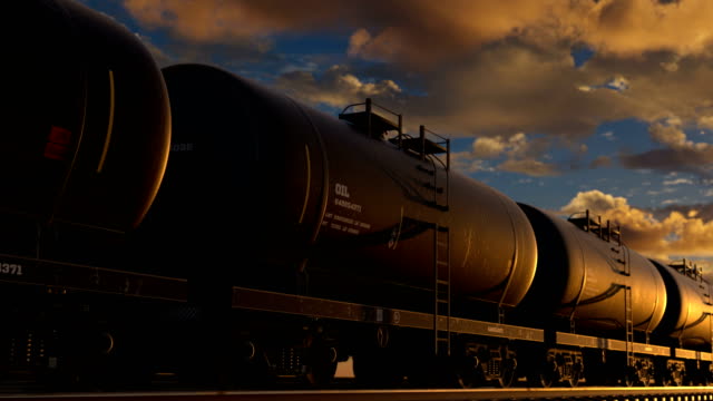 Transportation tank cars with oil during sunset. Oil tankers are transported by rail. The concept of development of the oil refining industry