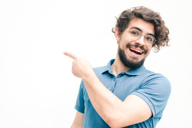 istock Joyful positive guy pointing finger away 1217806038