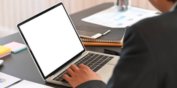 istock Cropped image of business executive men discussing about their business plan with computer laptop and graphic charts while sitting together at black meeting table over modern office as background. 1217806857