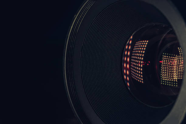 istock Close up beautiful camera lens with multi colored light bulb glass reflection. Macro view. 1217806899