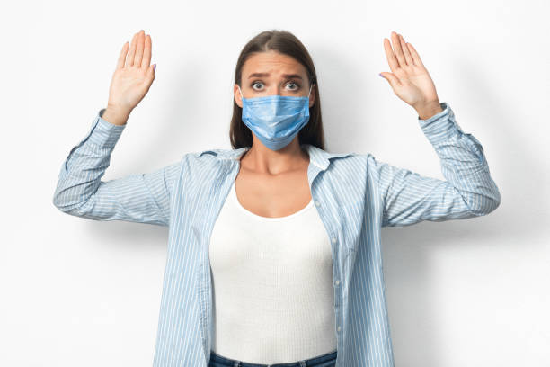 istock Woman In Mask Raising Hands Breaking Self-Quarantine Rules, White Background 1217807206