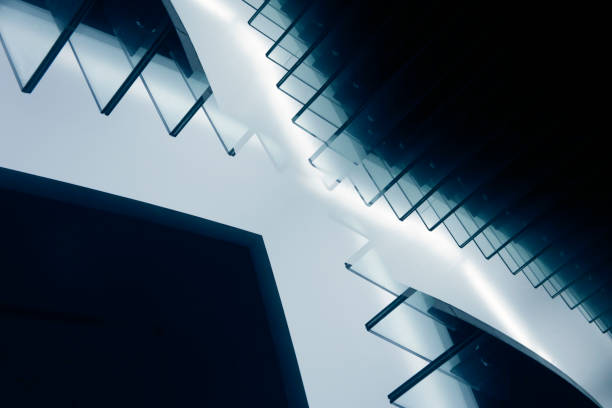 istock Computer graphic image of fututistic architecture fragment glowing in darkness. Stair-step structure with glass elements. Unusual abstract architectural or industrial background in hi-tech style. 1217807731