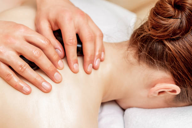 istock Stone massage on back of woman. 1217811511