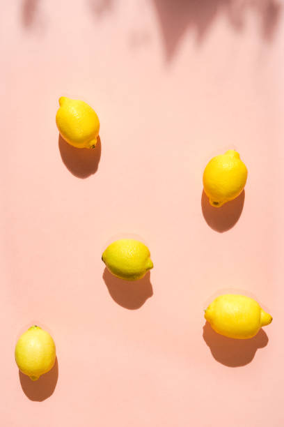 istock Overhead view of lemons on pink background 1217811738