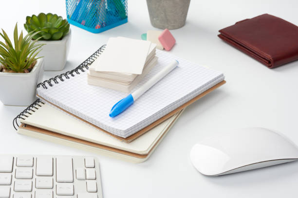 istock stack of notebooks, green plants in pots and a mouse, workplace of a freelancer 1217811916