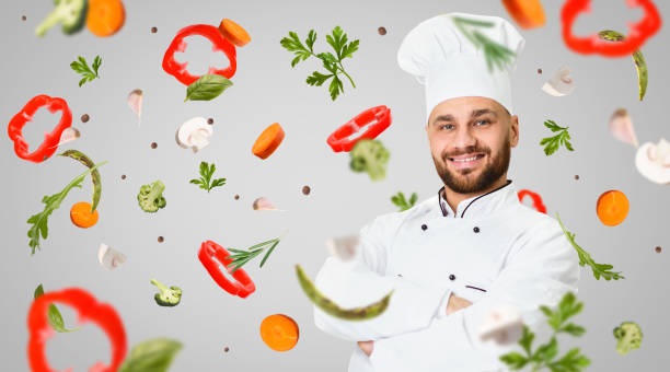 istock Healthy nutrition. Professional head chef and flying vegetables on grey background, collage. Blank space 1217813236