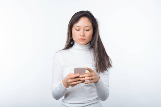istock young woman standing over white background and writing a message 1217813242