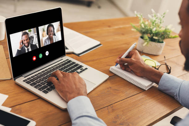 istock Unrecognizable black man watching business webinar at laptop and writing notes 1217813551